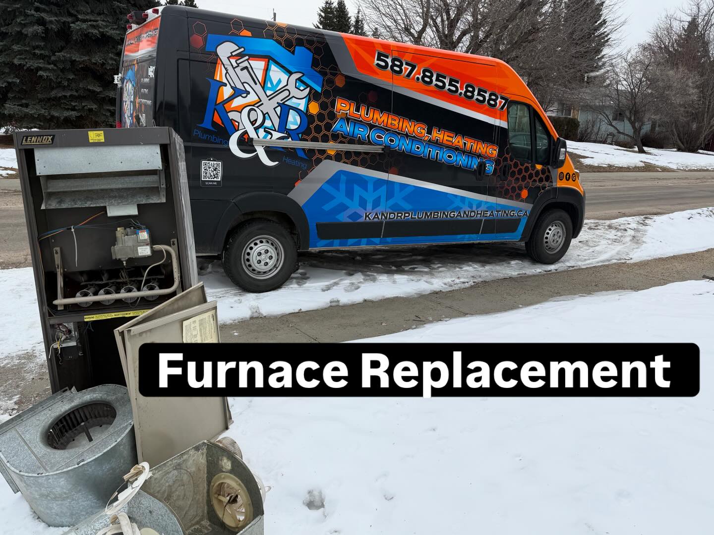Disassembled furnace parts on snow-covered ground beside a K&R Plumbing and Heating service van.
