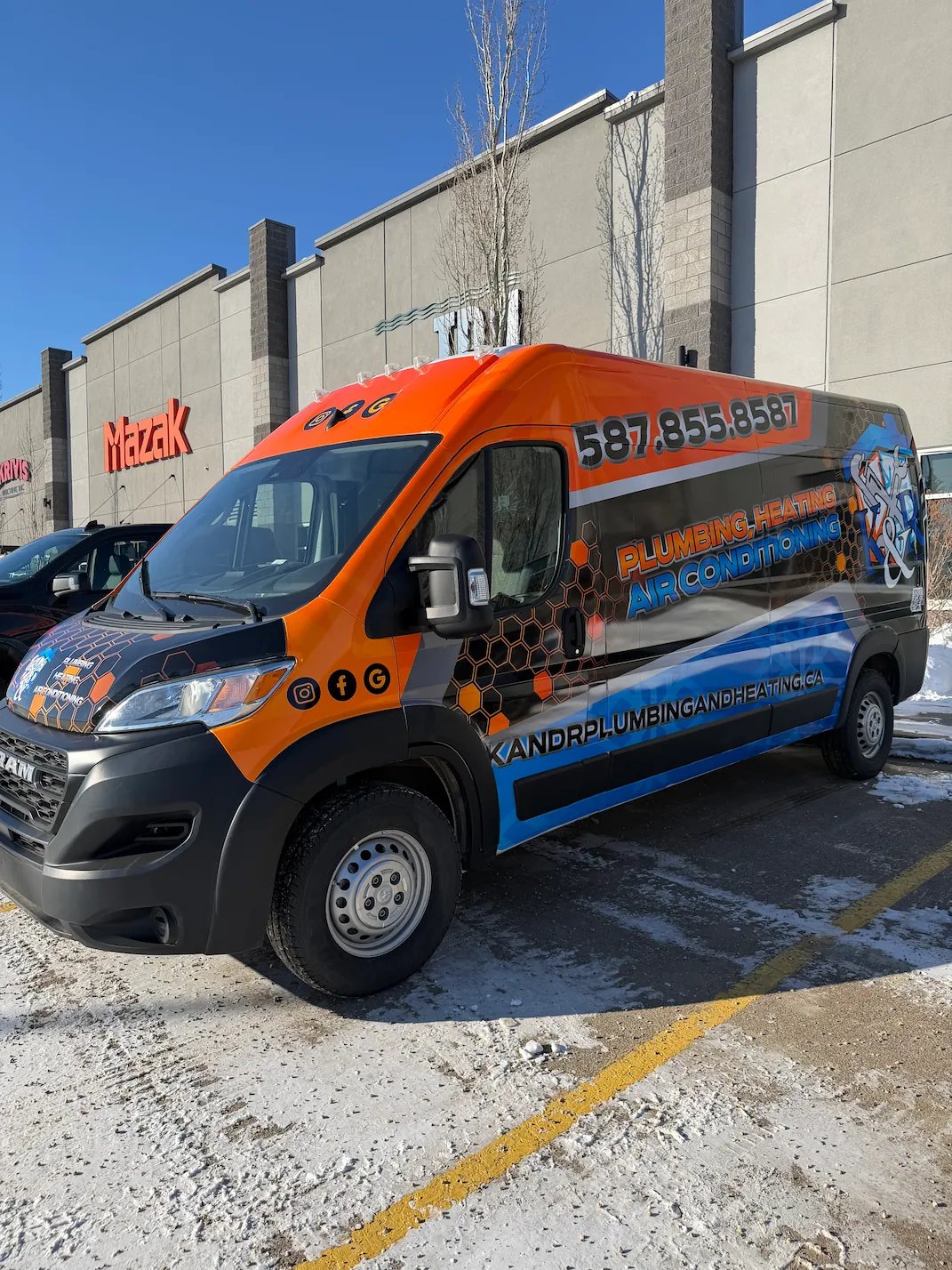 Black and orange service van for plumbing, heating, and air conditioning with phone number on side.
